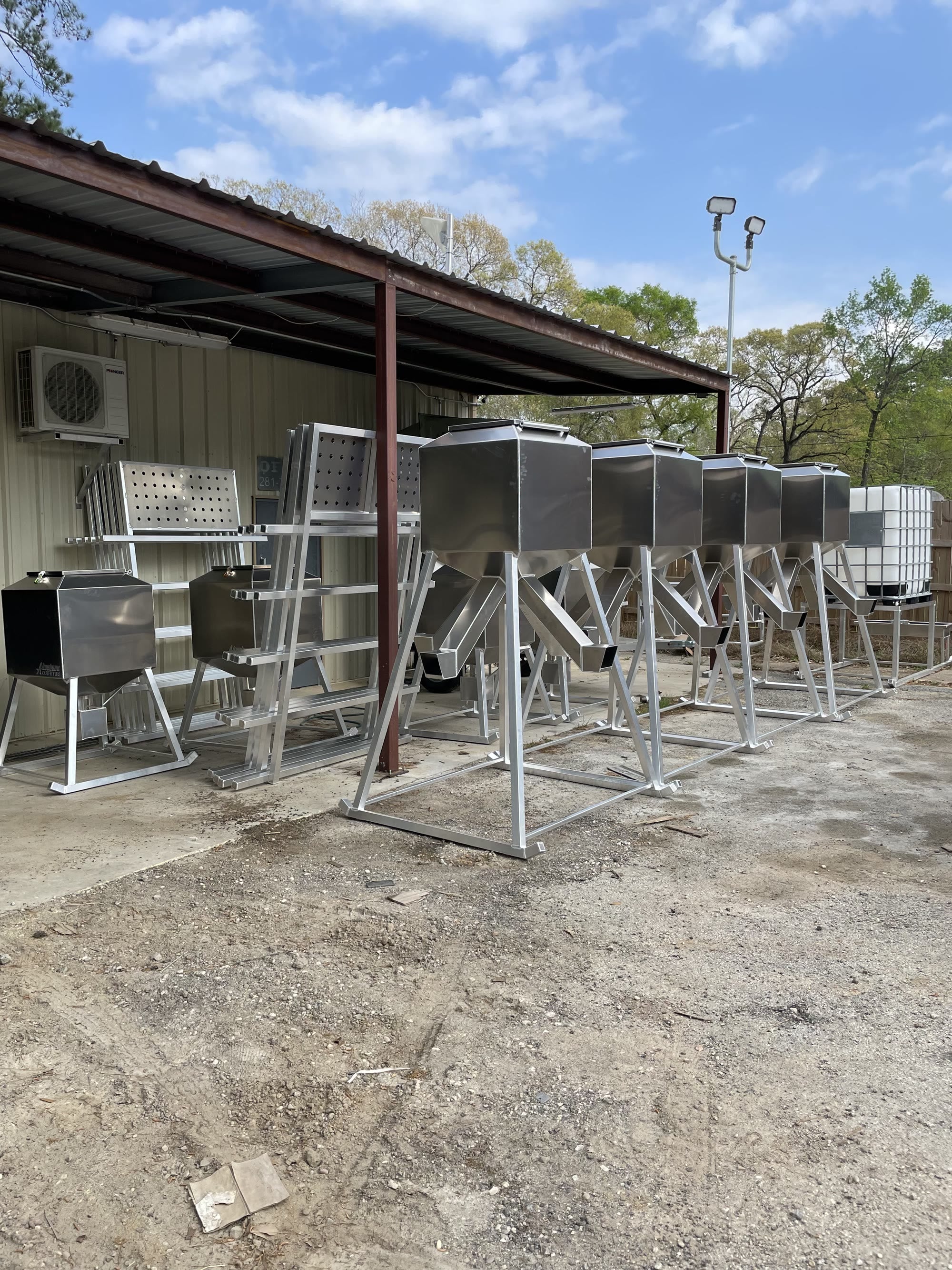 Aluminum Outfitters corn feeders lined up in the New Caney yard.