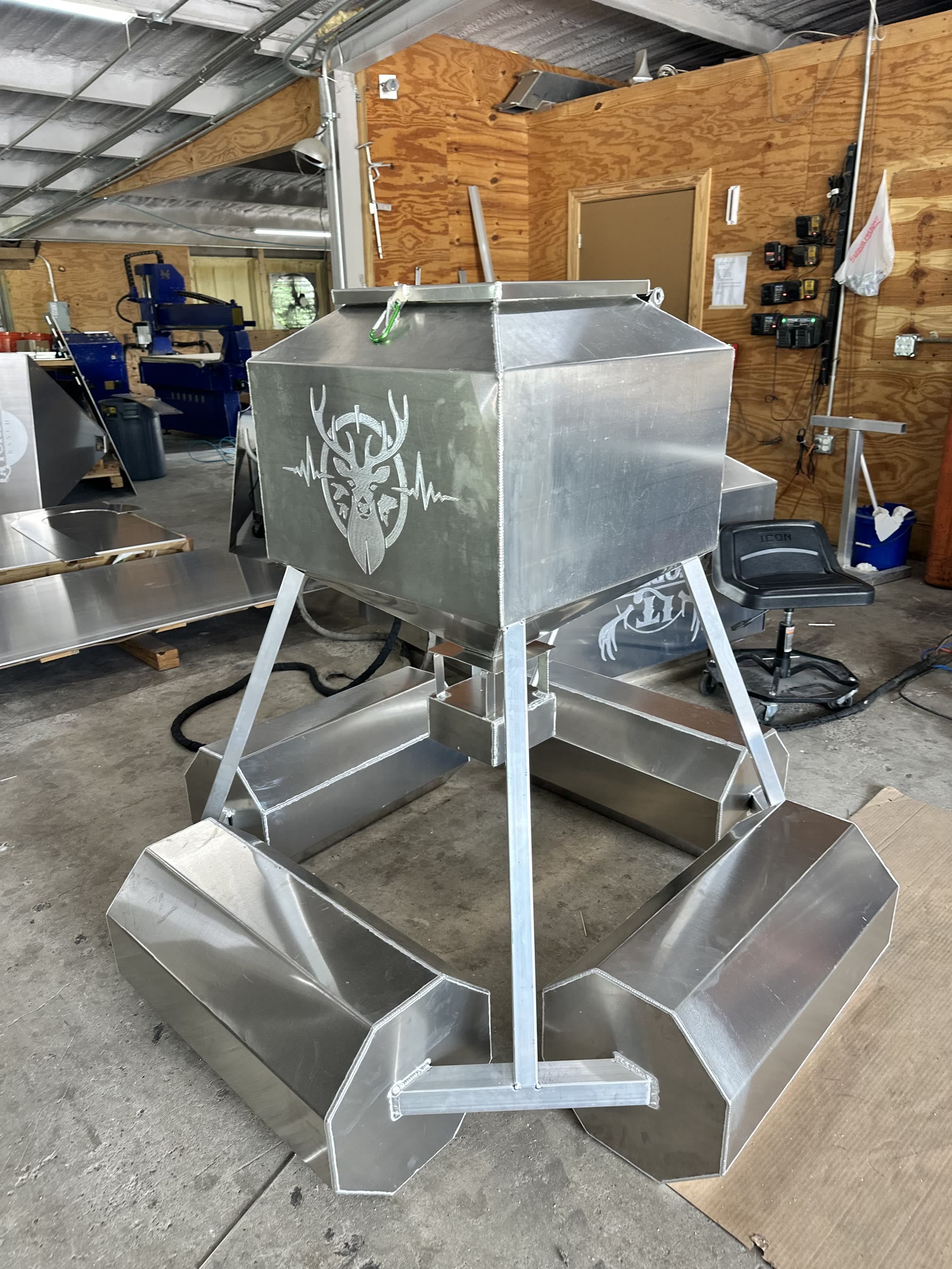 Aluminum floating fish feeder anchored on a pond.